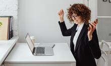 Excited woman on laptop